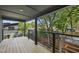 Outdoor deck with metal railings overlooking lush greenery and mature trees at 409 E Lee St, Raleigh, NC 27601