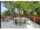 Beautiful outdoor deck featuring green trees, stylish chairs and dining table at 409 E Lee St, Raleigh, NC 27601