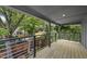 Outdoor deck with metal railings overlooking a private backyard and mature trees at 409 E Lee St, Raleigh, NC 27601