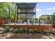 Outdoor deck with stylish seating, dining area, green plants, and a lovely view at 409 E Lee St, Raleigh, NC 27601