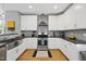 Modern kitchen with white cabinetry, stainless steel appliances, and grey subway tile backsplash at 409 E Lee St, Raleigh, NC 27601