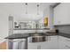 Modern kitchen with stainless steel sink, white cabinets, and gray subway tile backsplash at 409 E Lee St, Raleigh, NC 27601