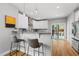 Modern kitchen features white cabinets, stainless steel appliances, bar seating and access to a deck at 409 E Lee St, Raleigh, NC 27601