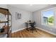 Bright home office with hardwood floors, natural light, and modern adjustable-height desk and office chair at 409 E Lee St, Raleigh, NC 27601