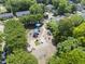 An aerial view of a public playground with colorful equipment, mature trees and bench seating at 409 E Lee St, Raleigh, NC 27601