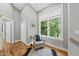Cozy sitting area featuring a cushioned chair with a blue throw blanket and natural light from a large window at 409 E Lee St, Raleigh, NC 27601