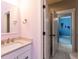 Bathroom featuring a vanity with black fixtures, a mirror, and a door leading to another room at 4104 Bankshire Ln, Raleigh, NC 27603