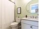 Bathroom featuring a shower, vanity with a round mirror, and neutral paint at 4104 Bankshire Ln, Raleigh, NC 27603