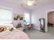 Pastel bedroom with pink walls, plush bedding, a desk, and a window that provides natural light at 4104 Bankshire Ln, Raleigh, NC 27603