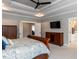 Bedroom featuring ample natural light, tray ceiling, and modern touches at 4104 Bankshire Ln, Raleigh, NC 27603