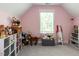 A well-organized bedroom featuring soft carpet, a window, and shelving filled with toys and stuffed animals at 4104 Bankshire Ln, Raleigh, NC 27603