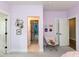 Bright bedroom with decorative wall art, an accent chair, and several doors leading to other rooms at 4104 Bankshire Ln, Raleigh, NC 27603