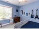Blue bedroom decorated with sports memorabilia, a dresser, and a window with natural light at 4104 Bankshire Ln, Raleigh, NC 27603