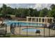 Inviting community pool with lounge chairs, umbrellas, and a jacuzzi surrounded by a secure fence at 4104 Bankshire Ln, Raleigh, NC 27603