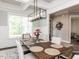 Dining room with natural lighting, an elegant light fixture, and decorative wainscoting at 4104 Bankshire Ln, Raleigh, NC 27603