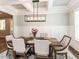 Elegant dining room with wainscoting, decorative lighting, and a rustic wood table at 4104 Bankshire Ln, Raleigh, NC 27603