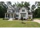 Stunning two-story home with charming front porch, complemented by lush landscaping at 4104 Bankshire Ln, Raleigh, NC 27603