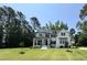 Charming two-story white farmhouse with black shutters, manicured lawn, and a welcoming front porch at 4104 Bankshire Ln, Raleigh, NC 27603