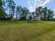 Exterior of home with lush green lawn and mature trees at 4104 Bankshire Ln, Raleigh, NC 27603