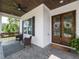 Inviting front porch with wood-stained front doors, a swing, seating, and a ceiling fan at 4104 Bankshire Ln, Raleigh, NC 27603