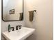 Half bathroom featuring a sink, mirror, and modern fixtures at 4104 Bankshire Ln, Raleigh, NC 27603