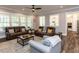 Inviting living room with hardwood floors, ceiling fan, modern furniture and lots of natural light at 4104 Bankshire Ln, Raleigh, NC 27603