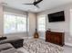 This cozy living room features an entertainment center, neutral colors, and a ceiling fan at 4104 Bankshire Ln, Raleigh, NC 27603