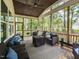 Relaxing screened-in porch featuring comfortable seating and views of the surrounding greenery at 4104 Bankshire Ln, Raleigh, NC 27603