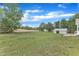 Expansive backyard with outbuildings and mature trees at 430 Sir David Dr, Zebulon, NC 27597
