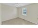 Neutrally painted bedroom featuring tile flooring and a window at 430 Sir David Dr, Zebulon, NC 27597