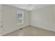 Neutral bedroom with tiled floors, a ceiling fan, and a bright window providing natural light and outdoor views at 430 Sir David Dr, Zebulon, NC 27597