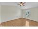 Spacious bedroom with hardwood floors, a ceiling fan, and a bright window offering natural light and backyard views at 430 Sir David Dr, Zebulon, NC 27597
