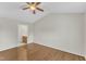Relaxing bedroom with hardwood floors, vaulted ceiling with fan, and doorway to the ensuite bathroom at 430 Sir David Dr, Zebulon, NC 27597