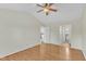 Inviting bedroom with hardwood floors, vaulted ceiling with fan, and open doorways to the kitchen and bathroom at 430 Sir David Dr, Zebulon, NC 27597