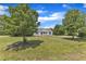 Landscaped front yard showcasing a cozy single-story home with a classic design and mature trees at 430 Sir David Dr, Zebulon, NC 27597