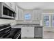Bright kitchen featuring stainless steel appliances, granite countertops, and white cabinetry at 430 Sir David Dr, Zebulon, NC 27597