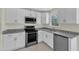 Kitchen showcasing granite countertops, stainless steel appliances, and white cabinets at 430 Sir David Dr, Zebulon, NC 27597