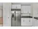 Kitchen featuring a stainless steel refrigerator, granite countertops, and white cabinets at 430 Sir David Dr, Zebulon, NC 27597