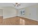 Bright living room features hardwood floors, a ceiling fan, and natural light from the window at 430 Sir David Dr, Zebulon, NC 27597