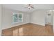 Inviting living room with hardwood floors, large window, and a ceiling fan, offering a cozy atmosphere at 430 Sir David Dr, Zebulon, NC 27597