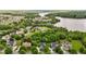 Aerial view showcasing a residential community with lush greenery and a serene lake at 4420 Bonnie Loch Dr, Burlington, NC 27215