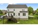 A beautiful backyard with a deck and stairs leading down to a well-maintained lawn at 4420 Bonnie Loch Dr, Burlington, NC 27215
