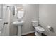 Bathroom featuring a pedestal sink and elongated toilet at 4420 Bonnie Loch Dr, Burlington, NC 27215
