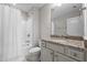 This bathroom features a vanity with granite countertop, a single sink, and a shower with a white curtain at 4420 Bonnie Loch Dr, Burlington, NC 27215