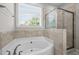 Bathroom featuring a corner tub and a glass door shower at 4420 Bonnie Loch Dr, Burlington, NC 27215