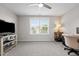 Bedroom features a ceiling fan, window, and desk setup at 4420 Bonnie Loch Dr, Burlington, NC 27215