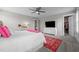 This bedroom features neutral walls, carpet flooring, a ceiling fan, and closet access at 4420 Bonnie Loch Dr, Burlington, NC 27215