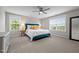 Bright bedroom features neutral walls, two windows, and a blue bed topped with colorful pillows at 4420 Bonnie Loch Dr, Burlington, NC 27215