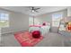Bright bedroom with a ceiling fan, two large windows, plush rug, and lots of natural light at 4420 Bonnie Loch Dr, Burlington, NC 27215