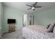 A green bedroom with a ceiling fan and a large window that offers natural lighting at 4420 Bonnie Loch Dr, Burlington, NC 27215